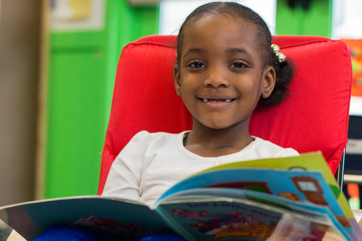 A child enjoying a BLueprint book.